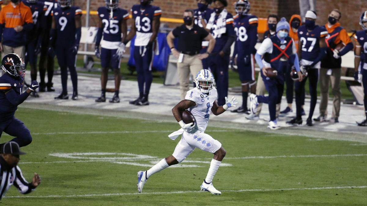 UNC’s Khafre Brown (1) dashes for a touchdown run in second quarter action against Virginia Saturday night, Oct. 31, 2020.
