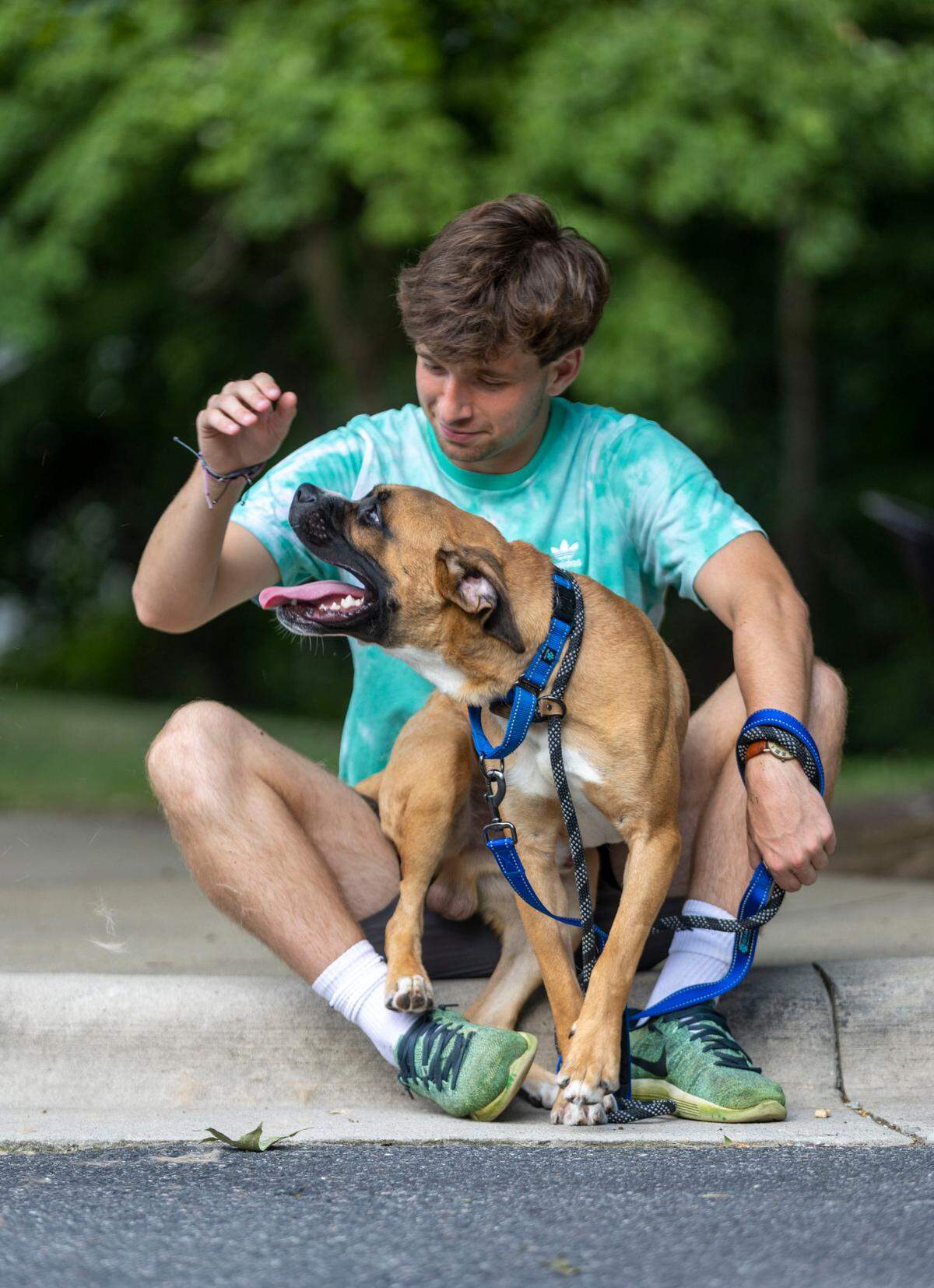 William Zipf McIntyre from Carolina Boxer Rescue plays with Crow, an eleven-month-old boxer mix, after picking him up from the Wake County Animal Center on Wednesday, July 6, 2022 in Raleigh, N.C.