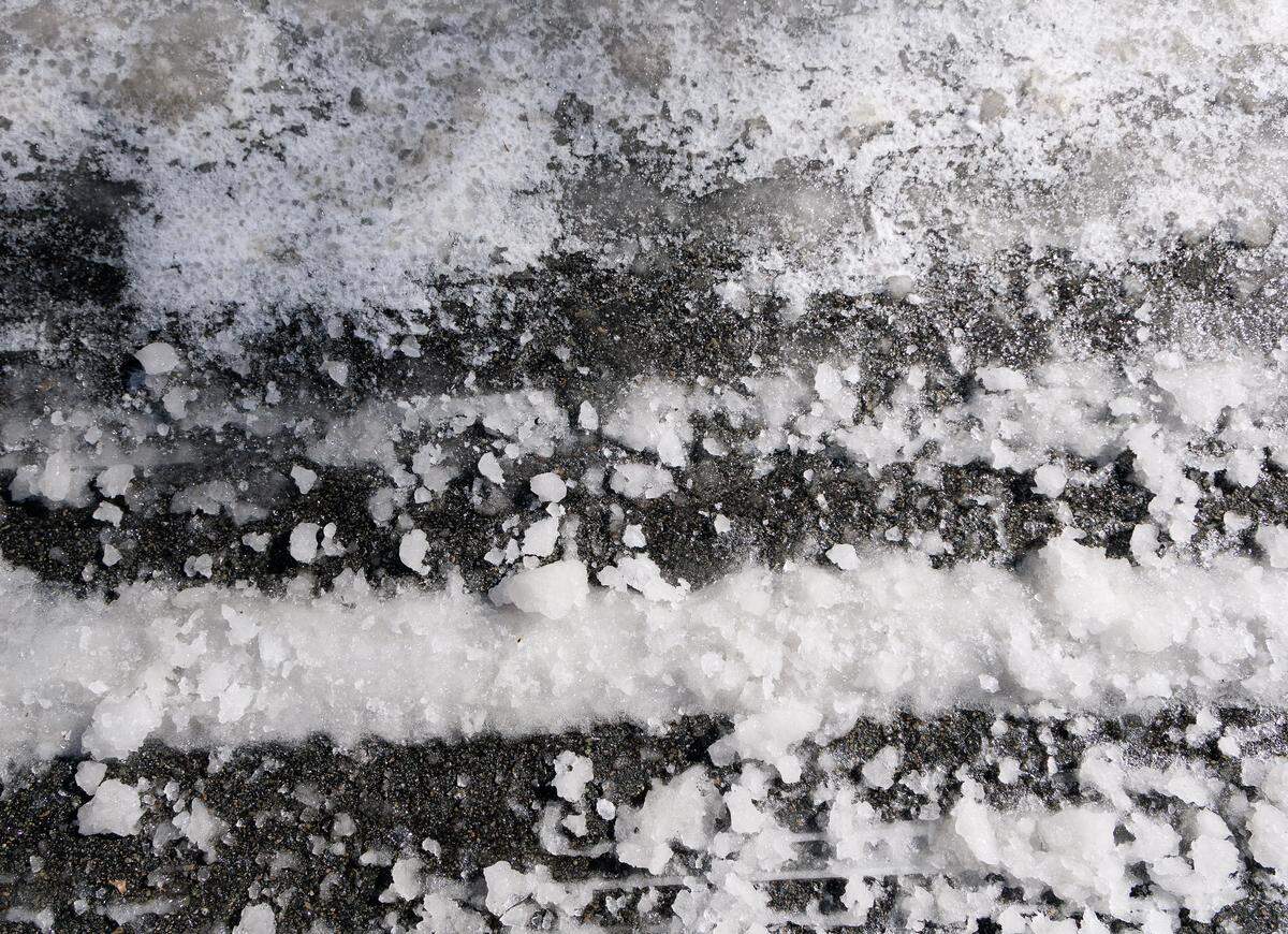 Snow and ice partially cover a neighborhood street off of West Cornwallis Road on Monday, Feb. 2, 2026, in Durham, N.C. 