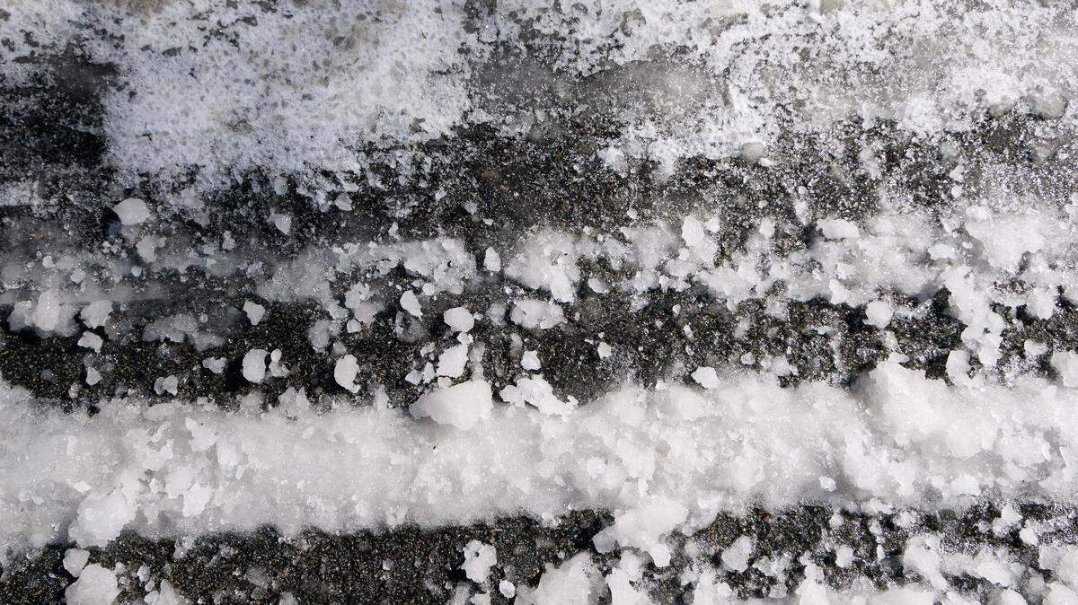 Snow and ice partially cover a neighborhood street off of West Cornwallis Road on Monday, Feb. 2, 2026, in Durham, N.C.