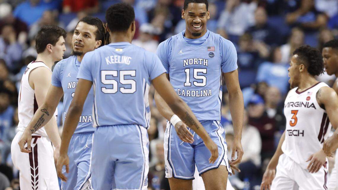 UNC’s Garrison Brooks (15) smiles as he congratulated by UNC’s Christian Keeling (55) during the first half of North Carolina Tar Heels’ game against the Virginia Tech Hokies in the first round of the ACC Tournament at Greensboro Coliseum in Greensboro, N.C., Tuesday, March 10, 2020.