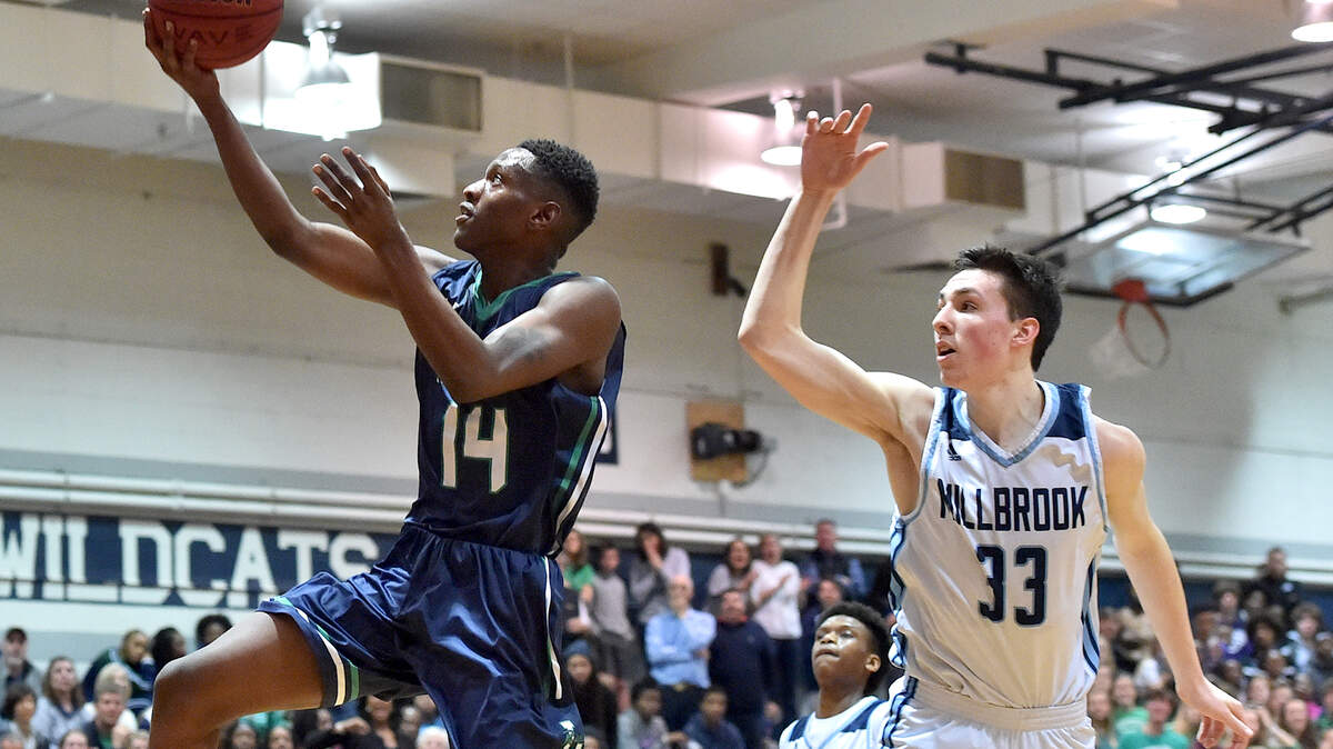 Leesville Road’s Deon Daniels (14) attempts the layup past Millbrook’s Sam Hood (33). The Leesville Road Pride and the Millbrook Wildcats met in the Cap-7 basketball semi-finals in Raleigh,N.C. on February 21, 2019.