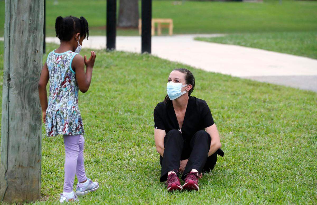 Erin Smith, family nurse practitioner with the Johnston County Public Health Department, talks with Rayona Jones as Jones waits for her mother after getting a COVID-19 vaccine shot during a pop up vaccine clinic in the Smithfield Housing Authoritys subdivision of Woodall Heights in Smithfield, N.C. Tuesday, June 8, 2021.