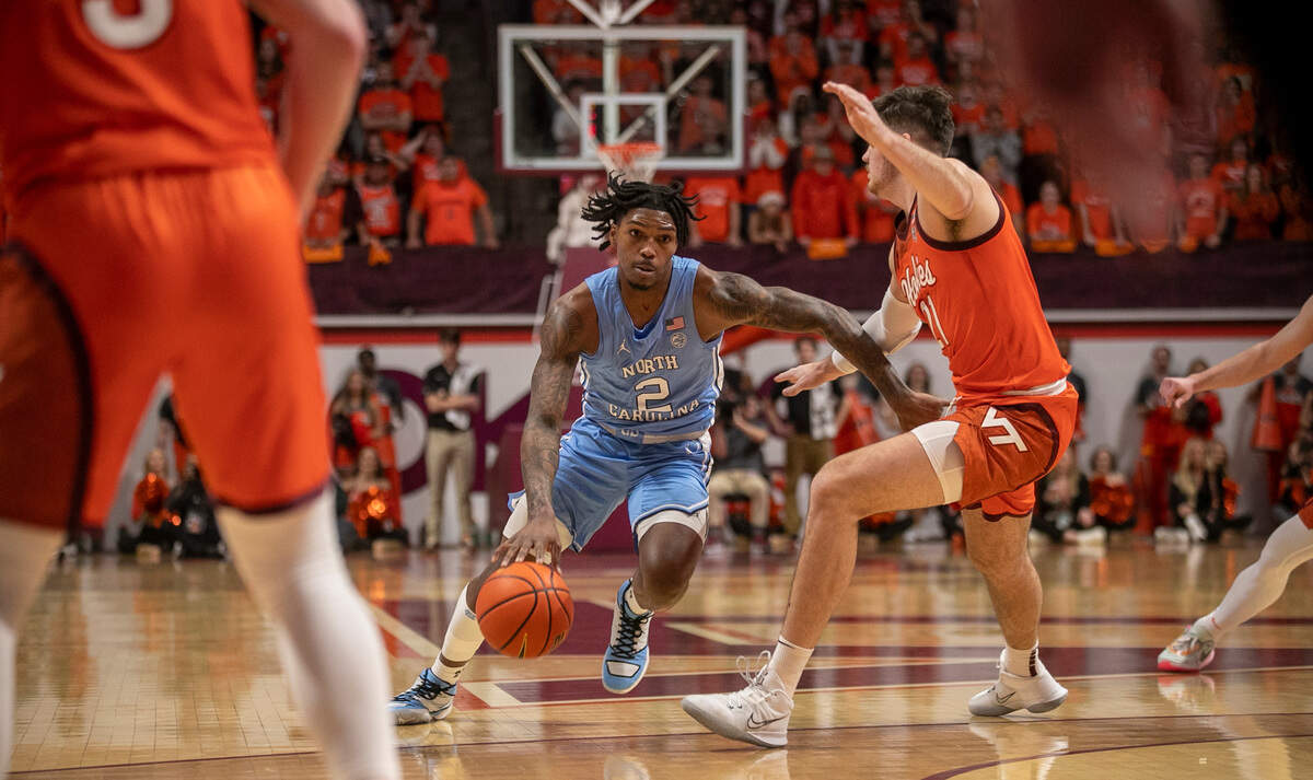 North Carolina’s Caleb Love (2) drives to the basket against Virginia Tech’s Grant Basile (21) during the first half on Sunday, December 4, 2022 at Cassell Coliseum in Blacksburg, Va.