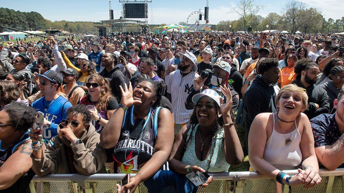 Fans cheer early peformers at the Dreamville Music Festival at Dix Park in Raleigh, N.C., Saturday, April 2, 2022.