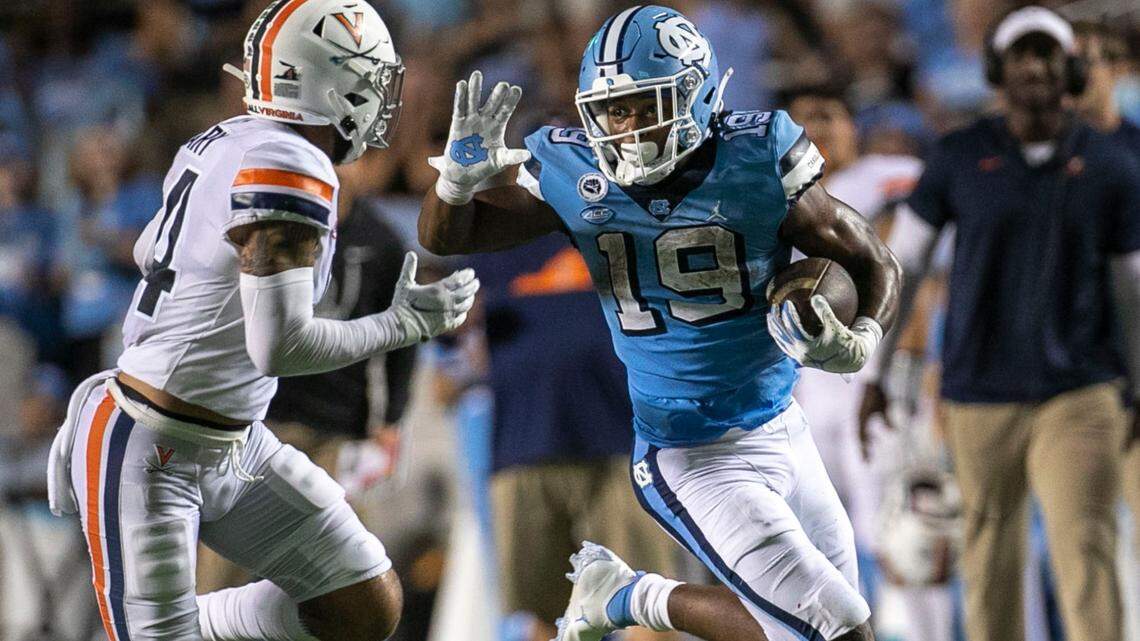 Virginia’s Elliott Brown (4) works to slow North Carolina’s Ty Chandler (19) on a 21-yard run in the third quarter on Saturday, September 18, 2021 at Kenan Stadium in Chapel Hill, N.C. Chandler rushed for 198 yards and two touchdowns.