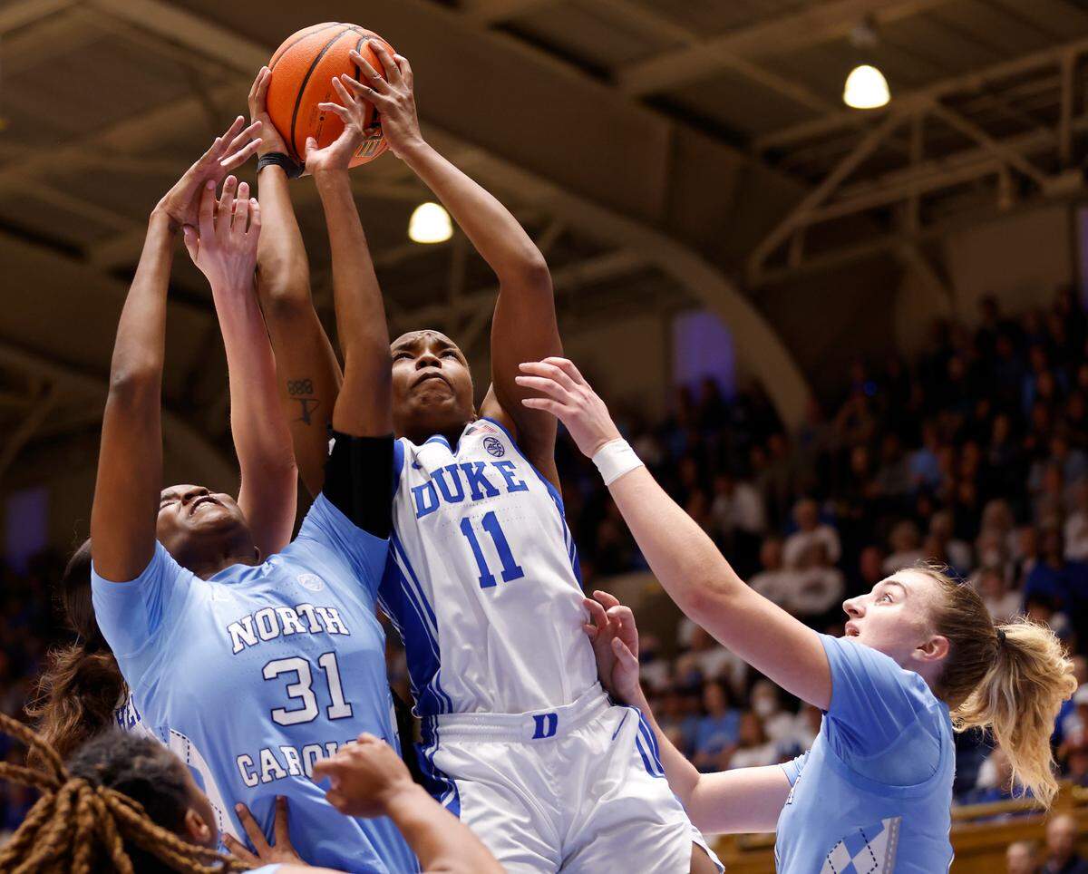 Duke’s Jordyn Oliver pulls down a rebound away from North Carolina’s Anya Poole and Alyssa Ustby during the first half of the Blue Devils’ regular season finale against North Carolina on Sunday, Feb. 26, 2023, at Cameron Indoor Stadium in Durham, N.C.