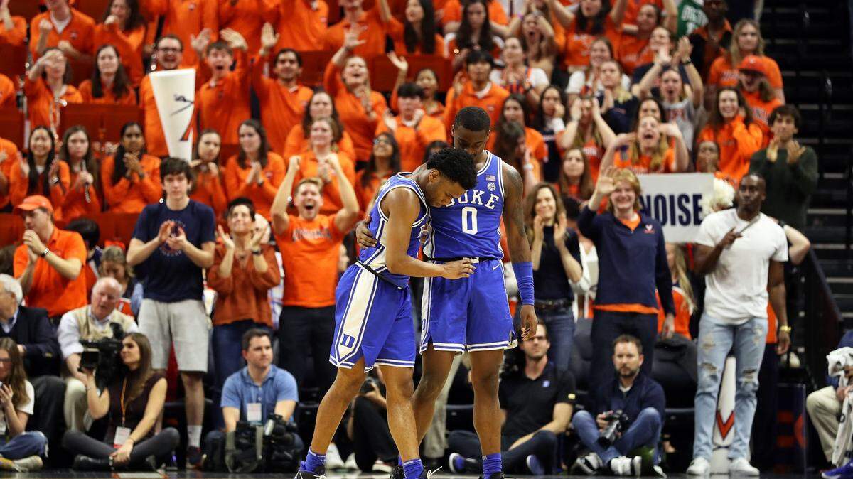 Duke’s Dariq Whitehead (0) assists Jeremy Roach off the court in overtime against Virginia at John Paul Jones Arena on Saturday, Feb. 11, 2023, in Charlottesville, Virginia. (Ryan M. Kelly/Getty Images/TNS)