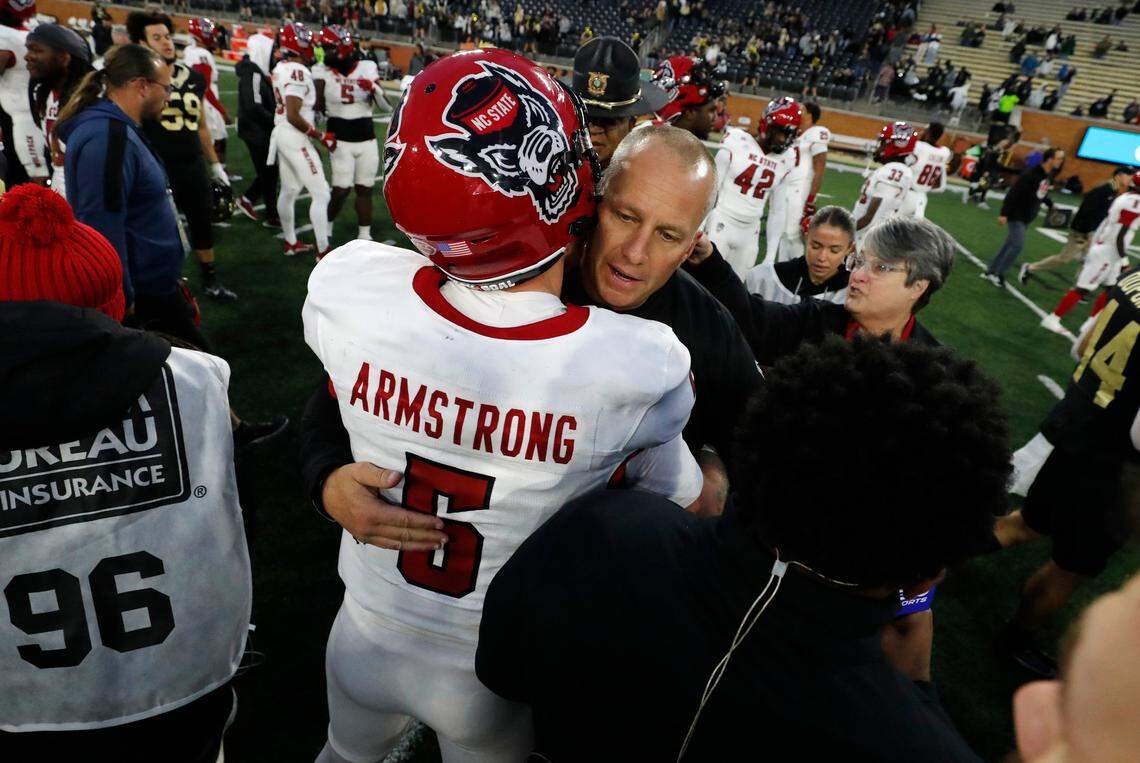 N.C. State head coach Dave Doeren hugs quarterback Brennan Armstrong (5) after N.C. State’s 26-6 victory over Wake Forest at Allegacy Stadium in Winston-Salem, N.C., Saturday, Nov. 11, 2023.