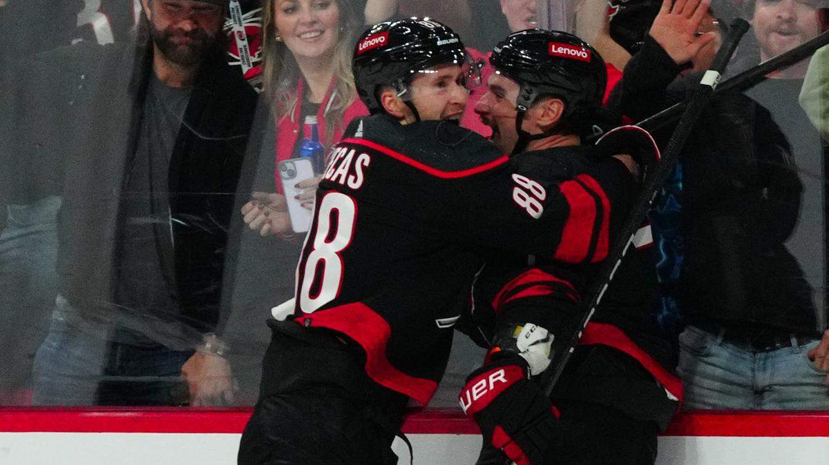 Jan 27, 2024; Raleigh, North Carolina, USA; Carolina Hurricanes defenseman Dmitry Orlov (7) celebrates his goal with center Martin Necas (88) against the Arizona Coyotes during the third period at PNC Arena. Mandatory Credit: James Guillory-USA TODAY Sports