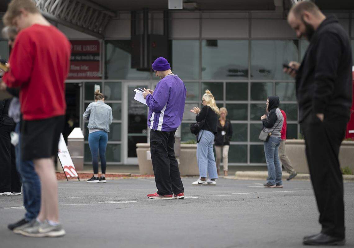 Philip Woodward, center, of Raleigh, N.C. practices social distancing with others as he waits to donate during an Emergency Blood drive on Thursday, March 26, 2020 at the PNC Arena in Raleigh, N.C.