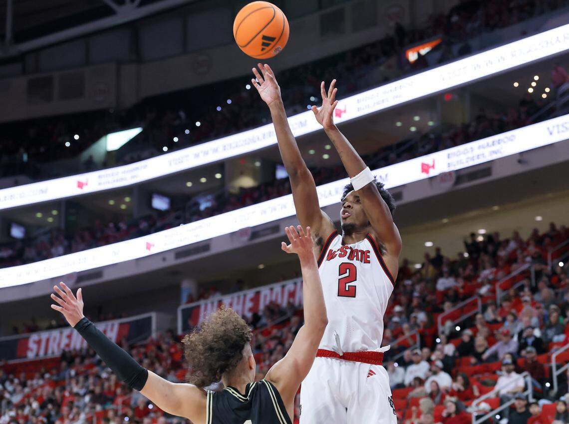 N.C. State’s Paul McNeil Jr. shoots over Wake Forest’s Nate Calmese during the first half of the Wolfpack’s game on Wednesday, Dec. 31, 2025, at Lenovo Center in Raleigh, N.C.