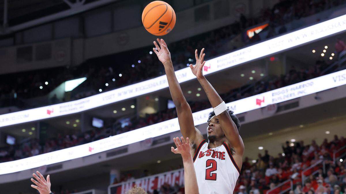 N.C. State’s Paul McNeil Jr. shoots over Wake Forest’s Nate Calmese during the first half of the Wolfpack’s game on Wednesday, Dec. 31, 2025, at Lenovo Center in Raleigh, N.C.