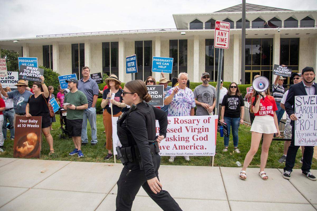 Several dozen abortion ban supporters at the Legislative Building counter-protest an abortion ban veto rally on Bicentennial Mall in Raleigh Saturday, May 13, 2023.