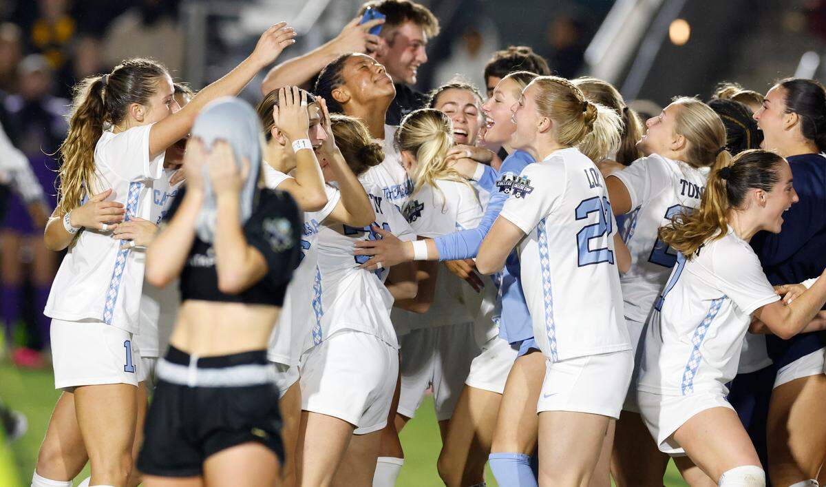 North Carolina players celebrate after time expired in UNC’s 1-0 victory over Wake Forest in the finals of the 2024 Women’s College Cup at WakeMed Soccer Park in Cary, N.C., Monday, Dec. 9, 2024. Wake Forest’s Emily Morris (13) is in the foreground.