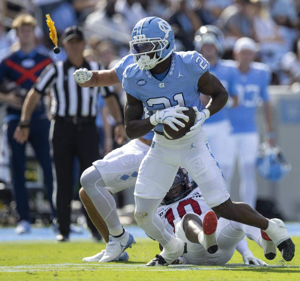 Officials toss yellow flags as North Carolina defensive back Kaleb Cost (21) is called for pass interference as he picks of a pass intended for Richmond wide receiver Isiah Dawson (10) in the second quarter on Saturday, September 13, 2025 at Kenan Stadium in Chapel Hill, N.C.
