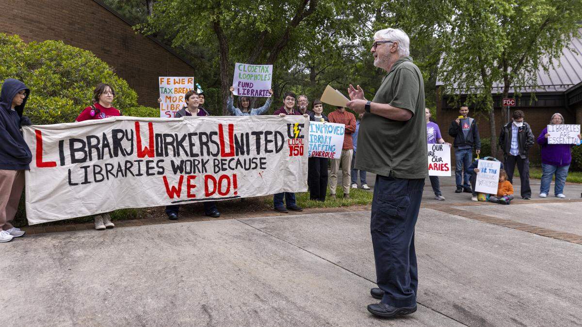 Cary resident, Steve Bader, speaks as Wake County library workers and supporters demonstrate outside the Wake County Commons Building in Raleigh before a public hearing on the county’s proposed fiscal 2027 budget on Monday, May 11, 2026. Protesters say chronic understaffing and reductions in staff hours are affecting library programming and services.