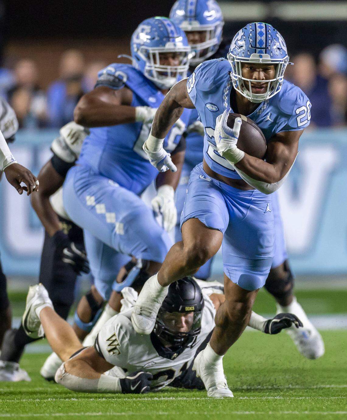 North Carolina running back Omarion Hampton (28) looks for running room on a 20-yard run in the first quarter against Wake Forest on Saturday, November 16, 2024 at Kenan Stadium in Chapel Hill, N.C.