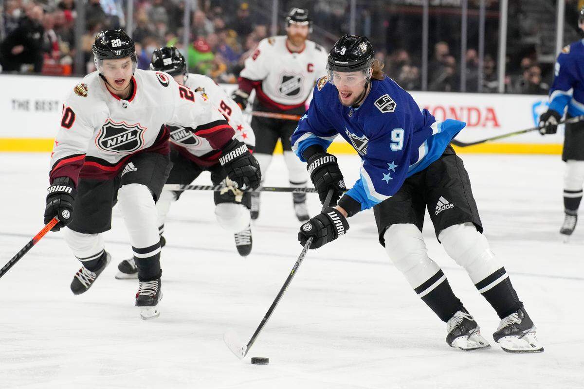 Pacific Division’s Adrian Kempe, of the Los Angeles Kings, right, skates with the puck against Metropolitan Division’s Sebastian Aho, of the Carolina Hurricanes, during the first period of a semifinal NHL All-Star hockey game Saturday, Feb. 5, 2022, in Las Vegas. (AP Photo/Rick Scuteri)