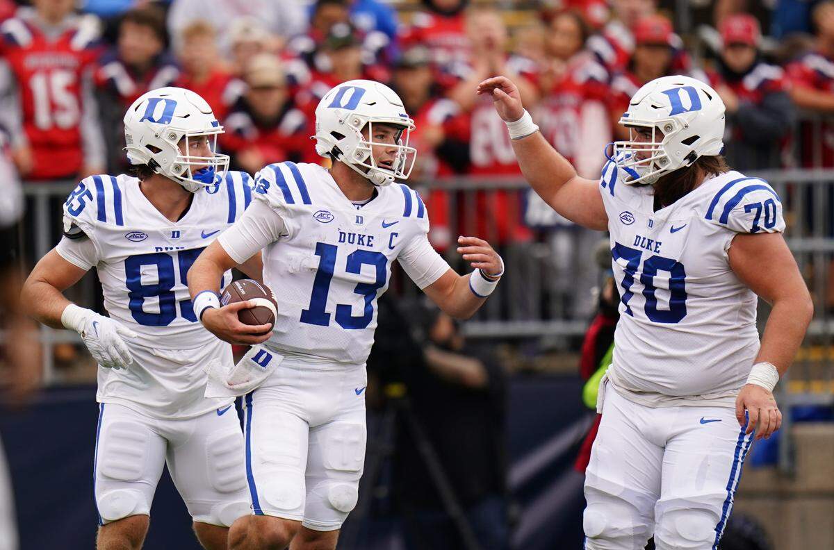 Sep 23, 2023; East Hartford, Connecticut, USA; Duke Blue Devils quarterback Riley Leonard (13) is congratulated after scoring a touchdown against the UConn Huskies in the second quarter at Rentschler Field at Pratt & Whitney Stadium. Mandatory Credit: David Butler II-USA TODAY Sports