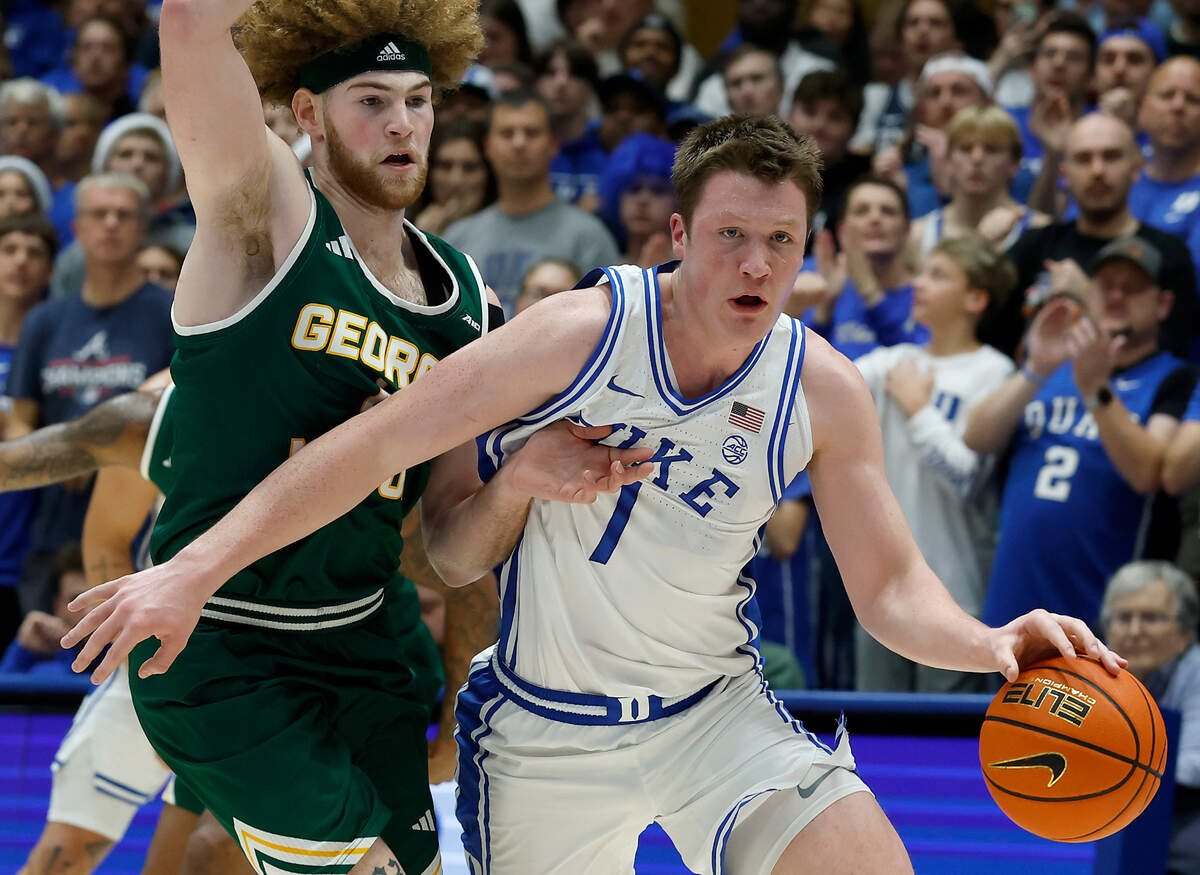 Duke’s Kon Knueppel drives past George Mason’s Brayden O’Connor during the first half of the Blue Devils’ game on Tuesday, Dec. 17, 2024, at Cameron Indoor Stadium in Durham, N.C.