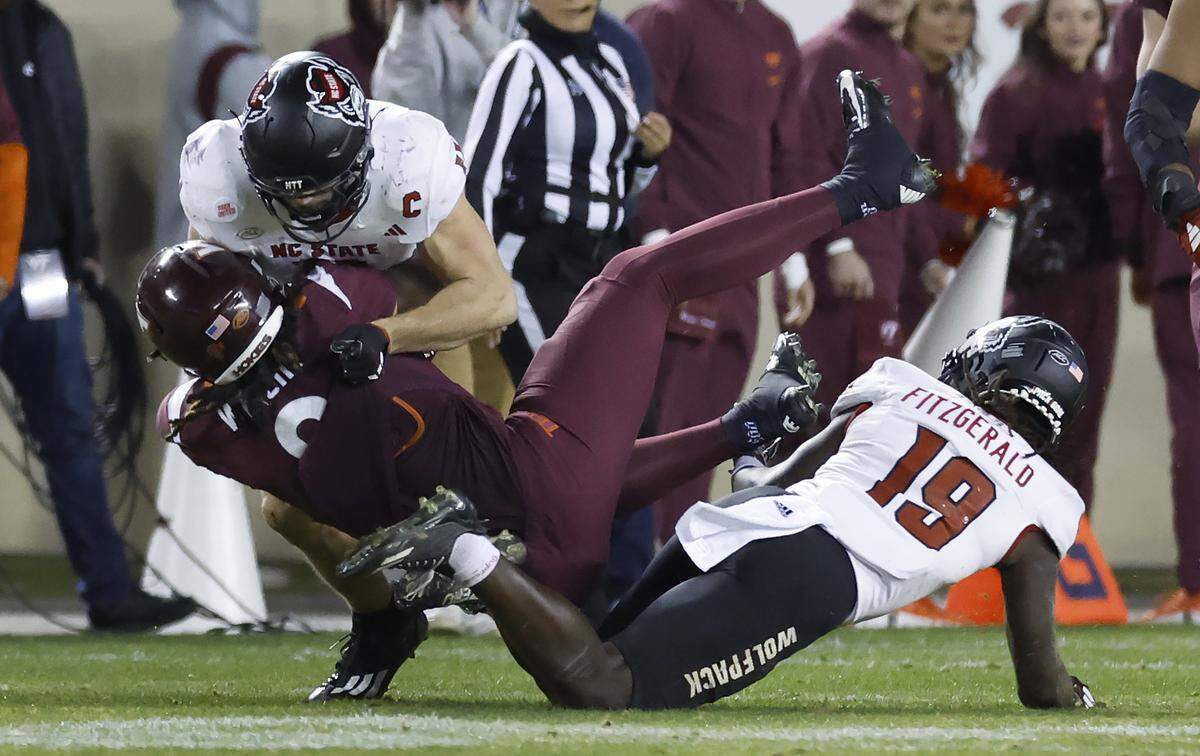 N.C. State linebacker Payton Wilson (11) tackles Virginia Tech tight end Dae’Quan Wright (8) during the second half of N.C. State’s 35-28 victory over Virginia Tech at Lane Stadium in Blacksburg, VA, Saturday, Nov. 18, 2023.