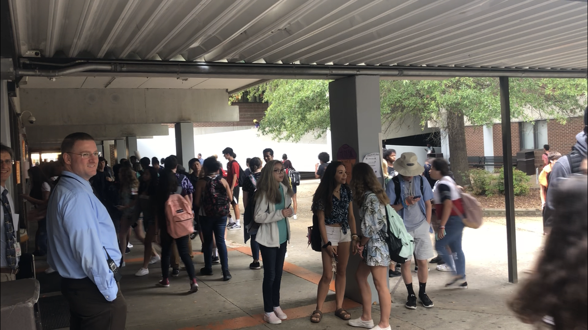Fuquay-Varina High School principal Jonathan Enns watches as students leave at the end of the school day on Oct. 9. 2018. Enns says a $111.8 million renovation planned for the school will help address issues such as how the many different buildings on campus pose security and circulation issues.