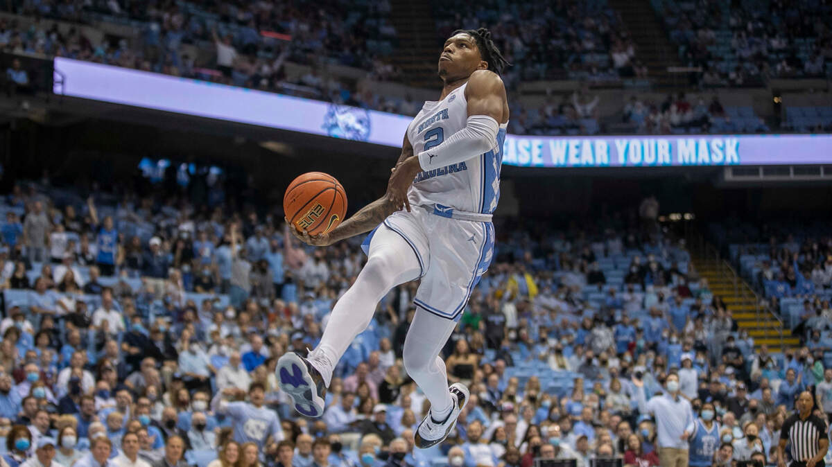 North Carolina’s Caleb Love (2) soars to the basket for a dunk during the first half against Elon on Saturday, December 11, 2021 at the Smith Center in Chapel Hill, N.C.