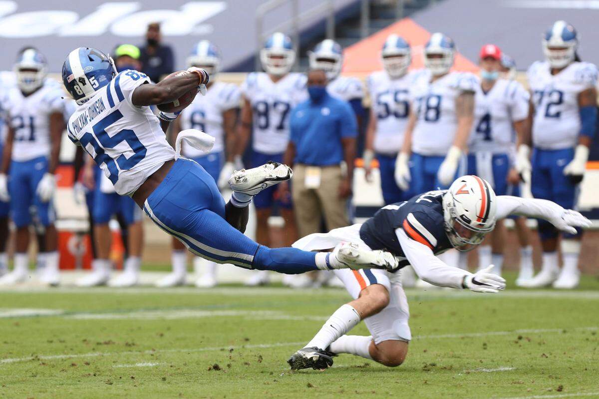 Duke wide receiver Damond Philyaw-Johnson (85) trips over a Virginia player during an NCAA college football game Saturday, Sept. 26, 2020, in Charlottesville, Va. (Erin Edgerton/The Daily Progress via AP)