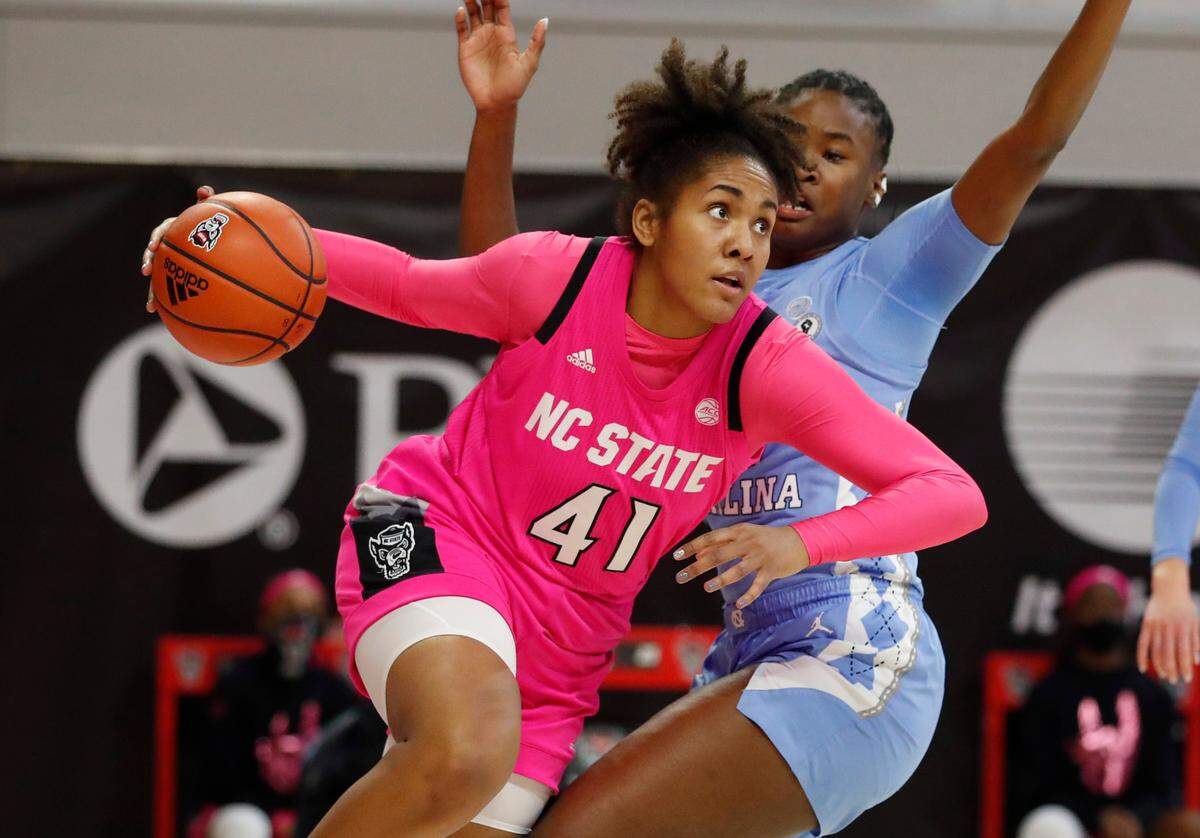 N.C. State’s Camille Hobby (41) drives by North Carolina’s Anya Poole (31) during the second half of N.C. State’s 82-63 victory over UNC in the annual Play4Kay game at Reynolds Coliseum in Raleigh, N.C., Sunday, February 21, 2021.