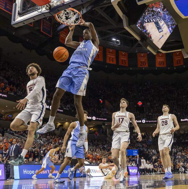North Carolina forward Caleb Wilson (8) breaks to the basket for a dunk against Virginia’s Sam Lewis (5) in the second half on Saturday, January 24, 2026 at John Paul Jones Arena in Charlottesville, Va. Wilson scored 20 points in the Tar Heels’ 85-80 victory.
