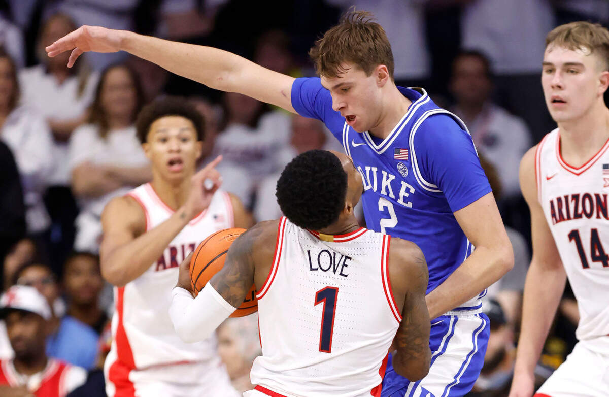 Duke’s Cooper Flagg (2) defends Arizona’s Caleb Love (1) during the second half of Duke’s 69-55 victory over Arizona at the McKale Memorial Center in Tucson, Ariz., Friday, Nov. 22, 2024.