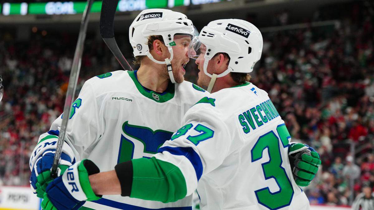 Feb 27, 2025; Raleigh, North Carolina, USA; Carolina Hurricanes right wing Mikko Rantanen (96) celebrates his goal with right wing Andrei Svechnikov (37) against the Buffalo Sabres during the first period at Lenovo Center. Mandatory Credit: James Guillory-Imagn Images