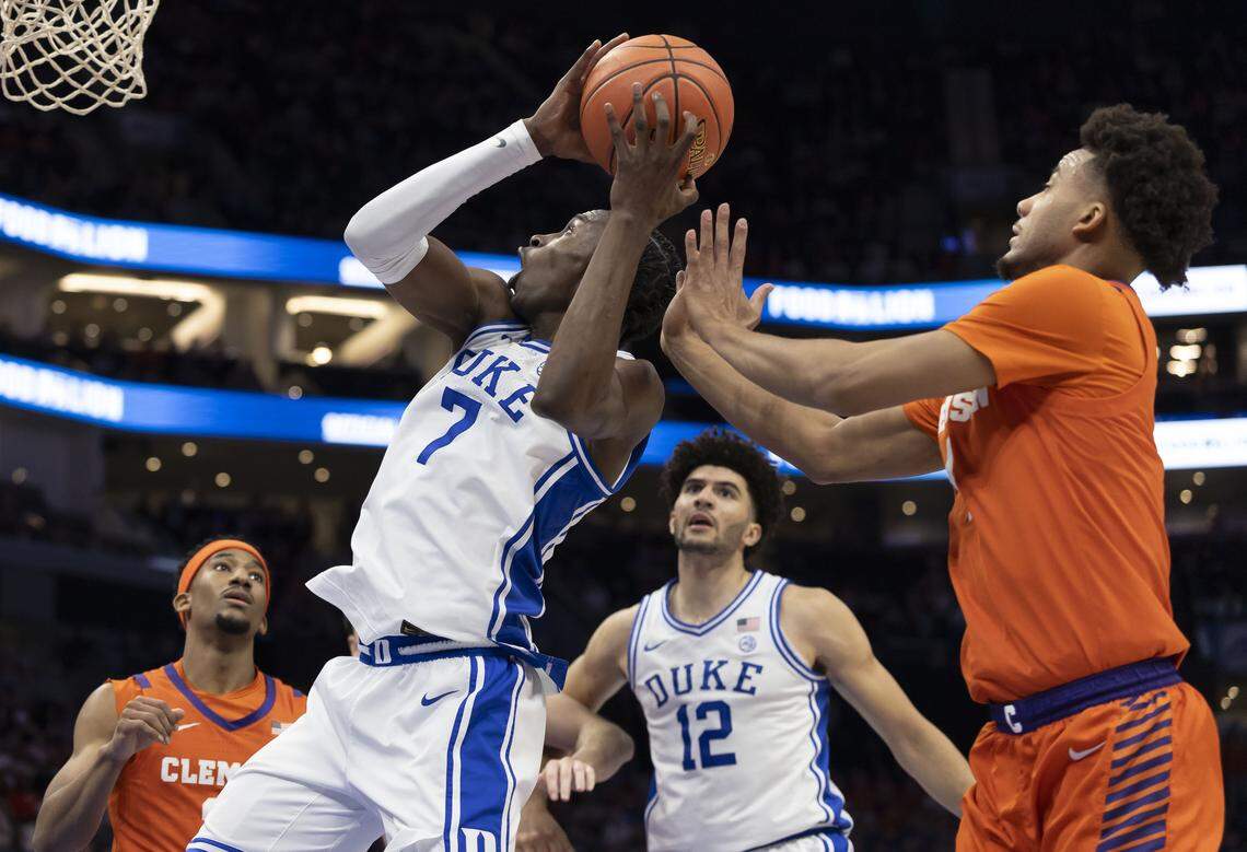 Duke guard Dame Sarr (7) drives to the basket against Clemson guard Efrem Johnson (4) in the first half on Friday, March 13, 2026, during the semifinals of the ACC Tournament at Spectrum Center in Charlotte, N.C.