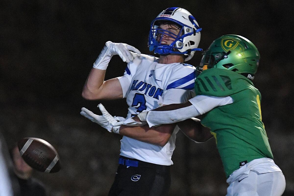 Cardinal Gibbons’ Corban McDaniel (1) defends Clayton’s Cort Schmidlin (3) from the pass during the first half. The Clayton Comets and the Cardinal Gibbons Crusaders met in the third round of the NCHSAA 4A Football Playoffs in Raleigh, N.C. on November 17, 2023.