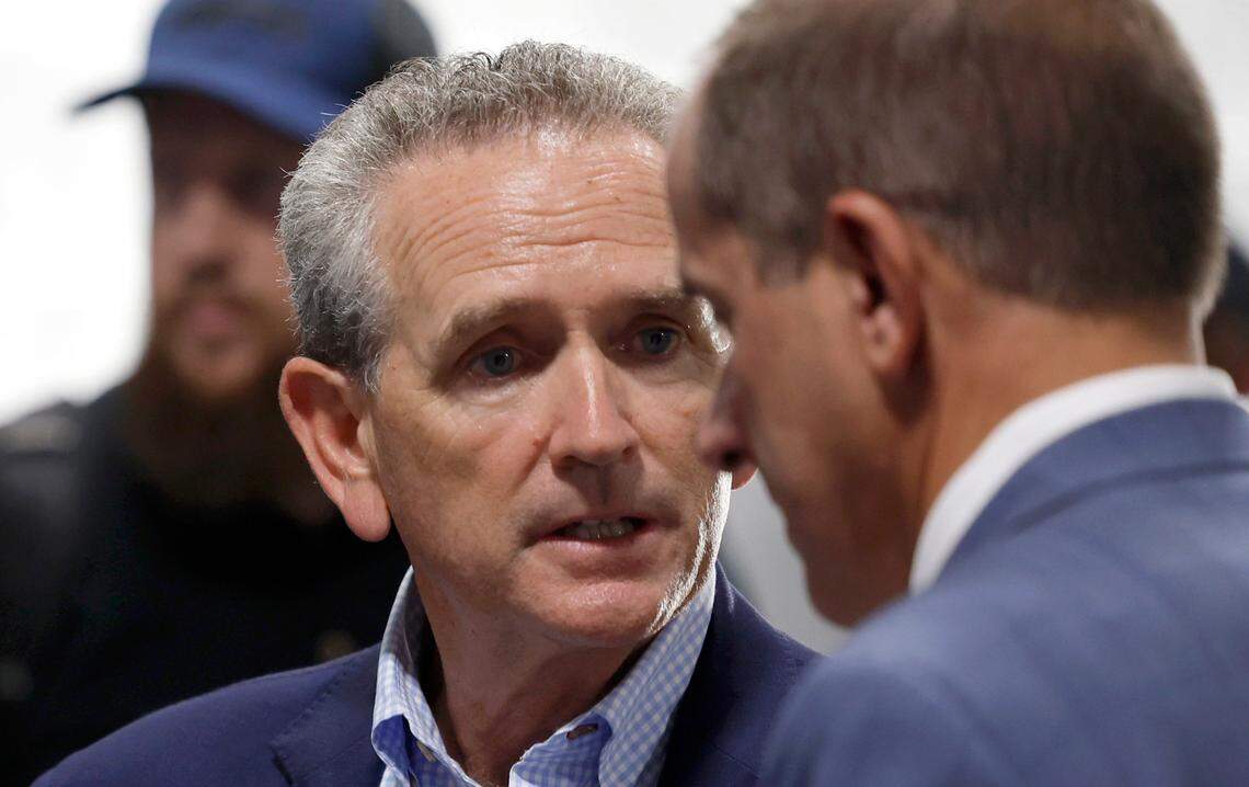 North Carolina athletic director Bubba Cunningham talks with ACC commissioner Jim Phillips before UNC’s game against South Carolina in the Duke’s Mayo Classic at Bank of America Stadium in Charlotte, N.C., Saturday, Sept. 2, 2023.