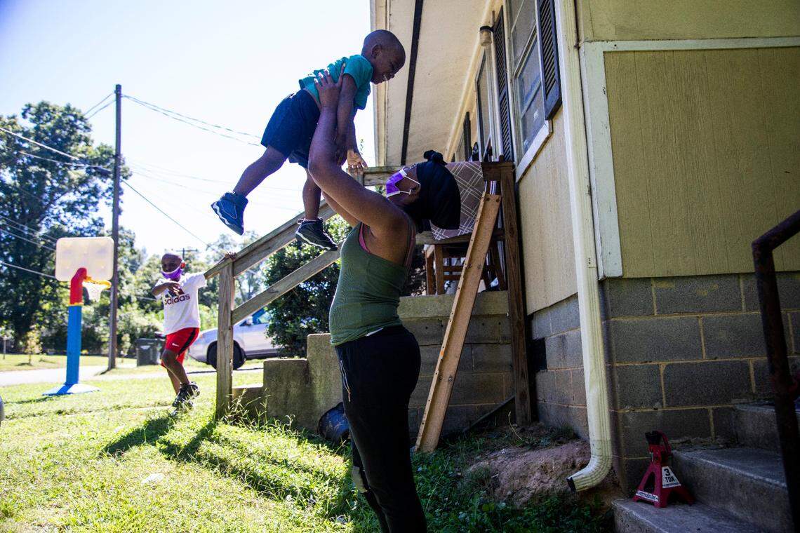 Akilia Jones, 31, spends time with her two sons, Dorian Jones, 6, left, and Quadarius Jones-Prescott, 2, at their apartment in east Durham. Jones is behind on rent and has applied for rental assistance with Durham County, which is prepared to reimburse all her rent arrears, but her landlord Rick Soles won’t accept the money.