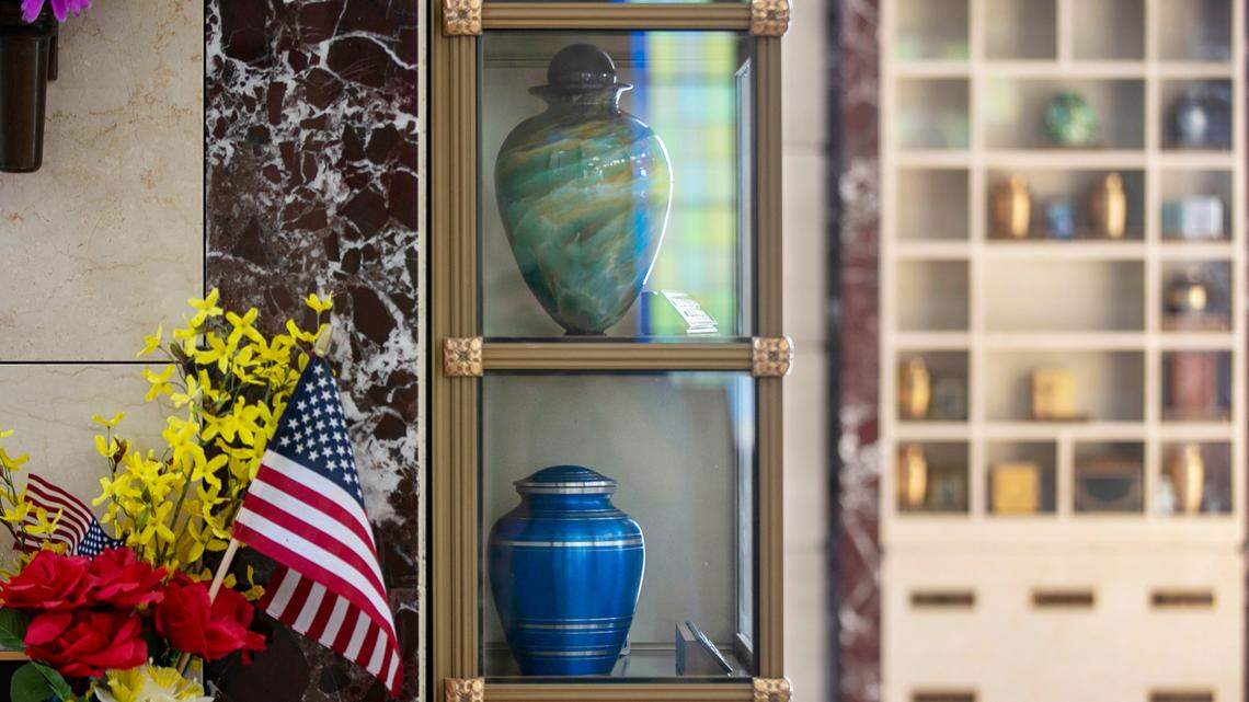 Inside the chapel at Raleigh Memorial Park, on Saturday June 19, 2021 in Raleigh, N.C., are glass columbarium’s where urns are displayed with personal objects reflecting the lives of those that chose cremation over traditional burials.