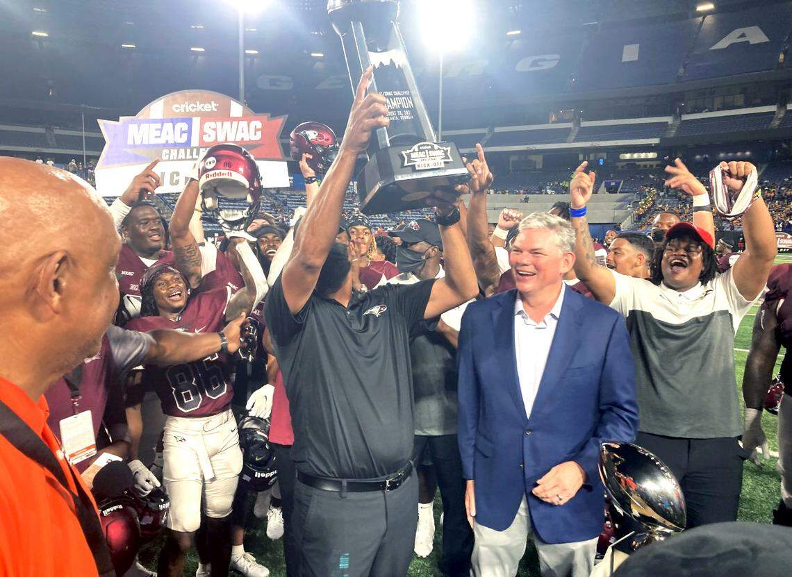 North Carolina Central University coach Trei Oliver holds up the championship trophy after NCCU’s 23-14 victory over Alcorn State in the MEAC/SWAC Challenge in Atlanta, Ga. Saturday, Aug. 28, 2021.