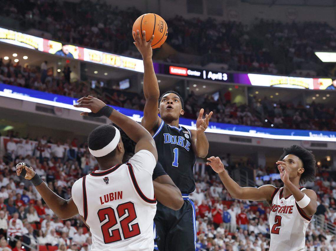 Duke’s Caleb Foster drives to the basket past NC State's Ven-Allen Lubin and Paul McNeil Jr. during the first half of the Blue Devils’ game on Monday, March 2, 2026, at Lenovo Center in Raleigh, N.C. 