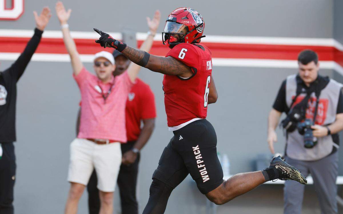 N.C. State’sTrent Pennix (6) celebrates scoring on a 62-yard touchdown reception during the second half of N.C. State’s 48-41 victory over Marshall at Carter-Finley Stadium in Raleigh, N.C., Saturday, Oct. 7, 2023.