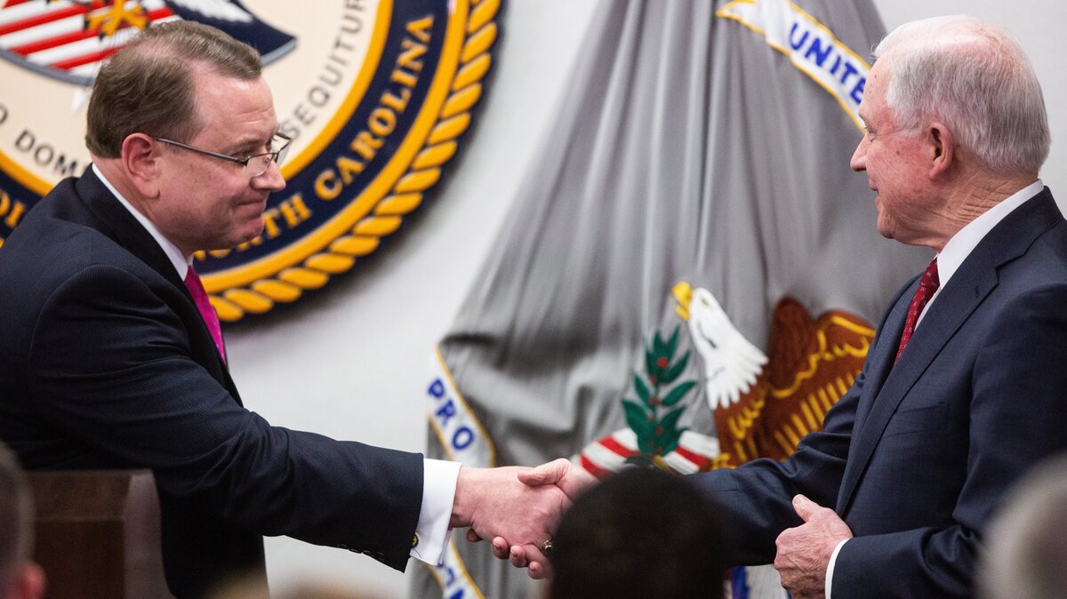 U.S. Attorney for the Eastern District of North Carolina, Robert J. Higdon Jr, left, shakes hands U.S. Attorney General Jeff Sessions, before Sessions spoke about the Trump administration’s plan to combat the nation’s opioid crisis Tuesday, April 17, 2018 at the U.S. Attorney’s Office for the Eastern District of North Carolina in Raleigh.