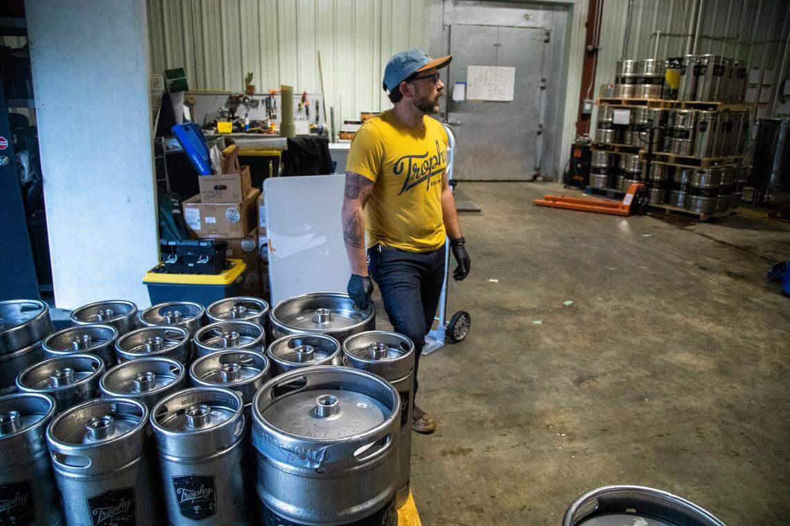 Chief Brewing Officer Les Stewart supervises operations at Trophy Brewing Company’s Maywood Avenue location in Raleigh Tuesday, May 19, 2020. Trophy started kegging more beers and brewing limited small batches in anticipation of selling to more restaurants as coronavirus restrictions are lifted. Stewart says they are taking a more cautious wait-and-see approach with the dine-in side of the business.
