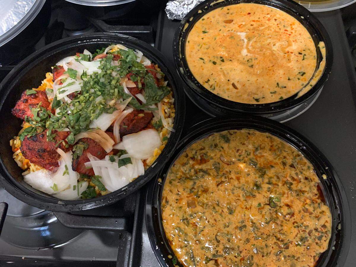 Cilantro Indian Cafe serves, clockwise from top right, Bihari coconut chicken curry, saag paneer and lamb kebabs.