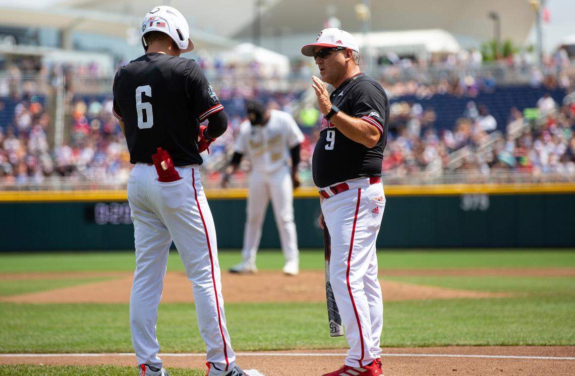 North Carolina State head coach Elliott Avent, right, talks with Vojtech Mensik before Mensik goes to bat again after his hit was called back as a foul ball after further review in the second inning against Vanderbilt during a baseball game in the College World Series, Friday, June 25, 2021, at TD Ameritrade Park in Omaha.