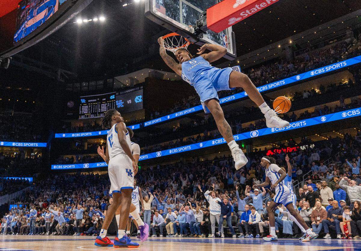 North Carolina’s Armando Bacot (5) reacts after a dunk on Kentucky’s Antonio Reeves (12) in the second half on Saturday, December 16, 2023 at State Farm Arena in Atlanta, Georgia.