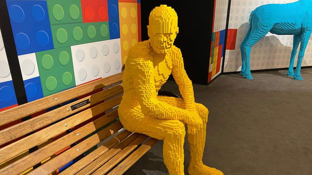 “Parkbench” by Nathan Sawaya, constructed entirely of yellow Legos, now on view in a Raleigh gallery.