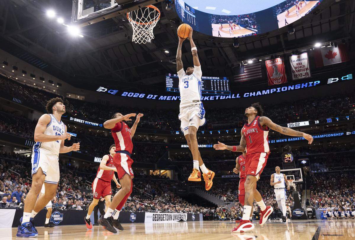 Duke forward Isaiah Evans (3) breaks to the basket for a dunk in the first half against St. John’s during the Sweet Sixteen of the NCAA Tournament on Friday, March 27, 2026, at Capital One Arena in Washington, D.C.  Evans lead all scores with 25 points in the Blue Devils’ 80-75 victory. 