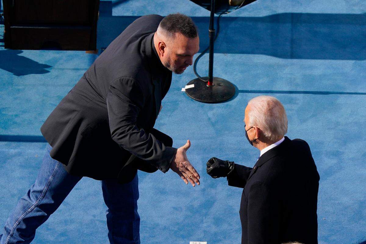 Country singer Garth Brooks reaches out to greet President Joe Biden during the 59th Presidential Inauguration at the U.S. Capitol in Washington, Wednesday, Jan. 20, 2021.