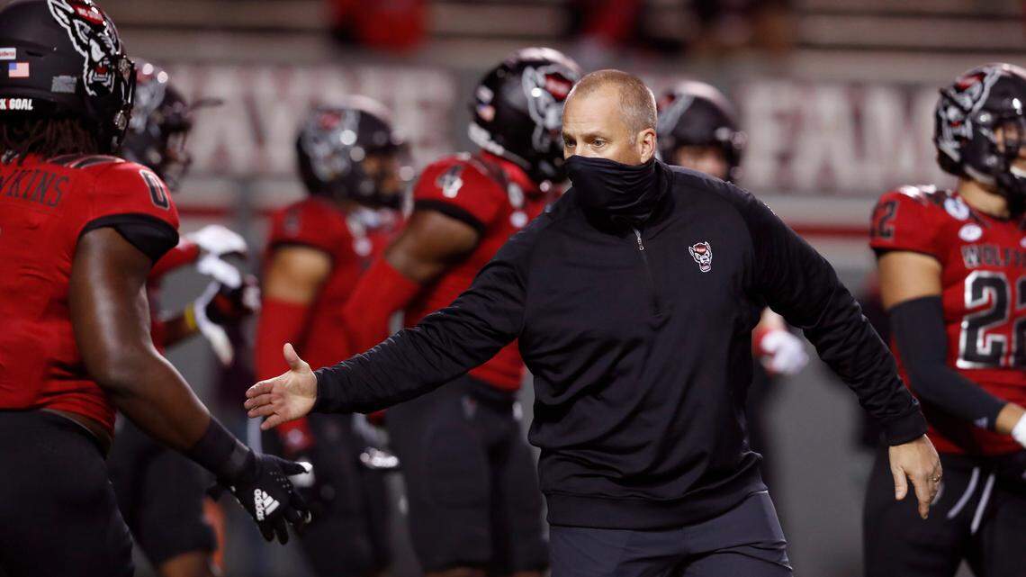 N.C. State head coach Dave Doeren encourages Terrell Dawkins (0) during warmups before N.C. State’s game against Florida State at Carter-Finley Stadium in Raleigh, N.C., Saturday, Nov. 14, 2020.